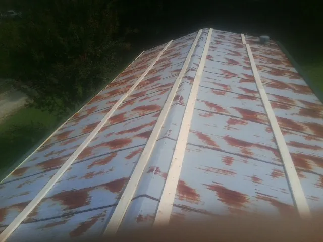 Rusted metal roof panels with new wood purlins before replacement — Storm Damage Roof Repair in Lititz by Roofing Brothers