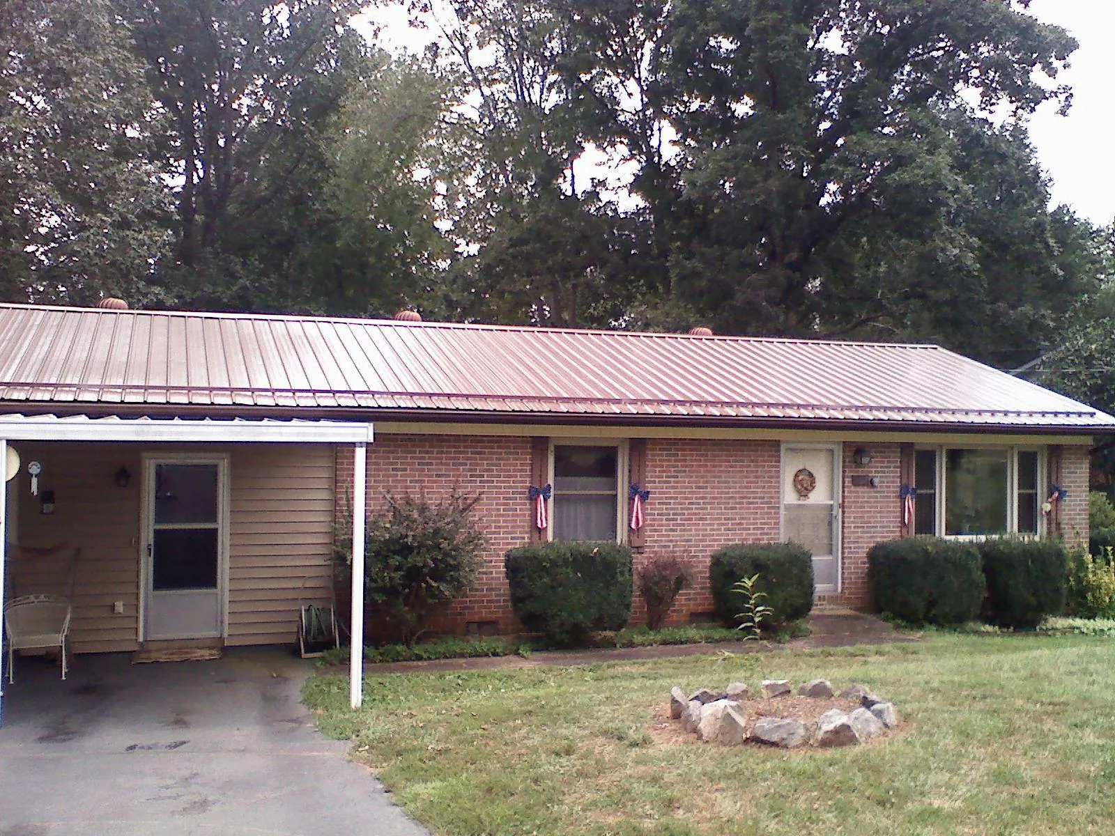 Bronze metal roof and carport on a brick ranch home — Roof Repair work by our crew in Lititz