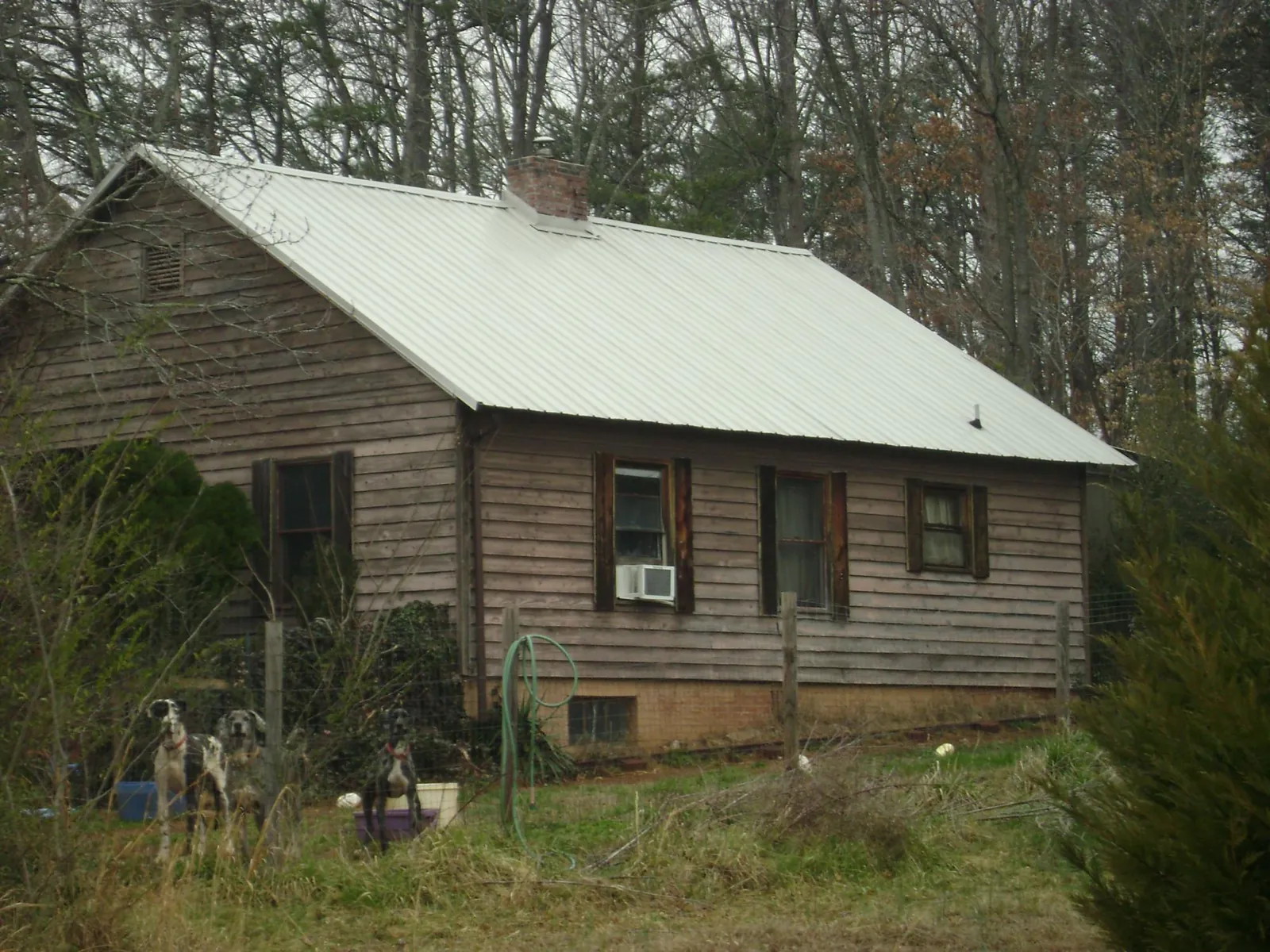 White metal roof on an old wood sided farmhouse, from a Metal Roof Installation job in Lititz